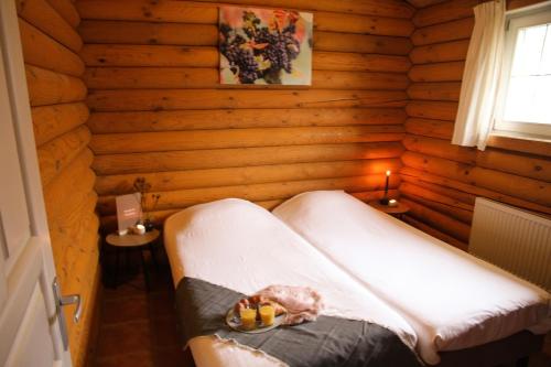 Habitación con cama en una cabaña de madera en Wijngaard Saalhof, en Wognum