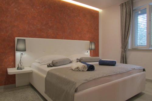 a bedroom with a large bed with two pillows on it at Villa Mirosa in Saplunara