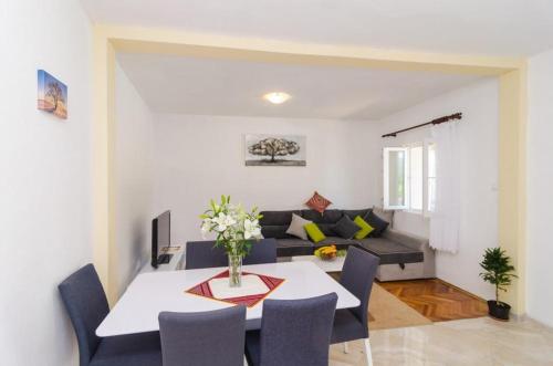a living room with a table and a couch at Villa Dalmatian Gem in Gruda