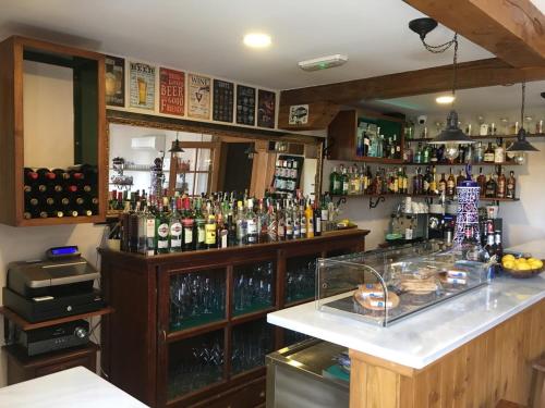 a bar with a lot of bottles of alcohol at Hotel Colonial de Santillana in Santillana del Mar