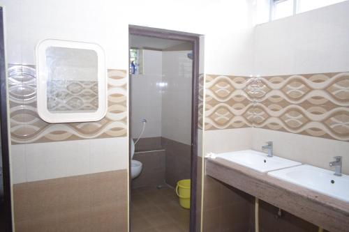 a bathroom with a sink and a mirror at Sri Krishna Vilas in Coimbatore