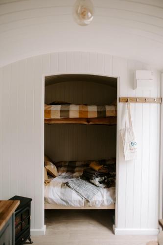 a bedroom with a bunk bed in a wall at Angela's Rest Shepherds Hut with Scandi Hot Tub in Boston