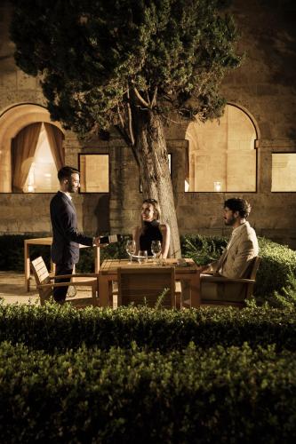 a man giving a woman a glass of wine at Abadia Retuerta LeDomaine in Sardoncillo