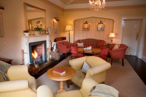 a living room with couches and a fireplace at Hazel Bank Country House Borrowdale Valley in Rosthwaite