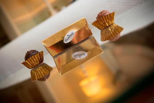 three chocolate muffins in a gold box on a table at Hazel Bank Country House Borrowdale Valley in Rosthwaite