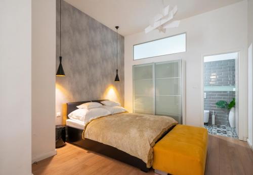 a bedroom with a bed and a large window at Baross Boutique Apartman in Győr