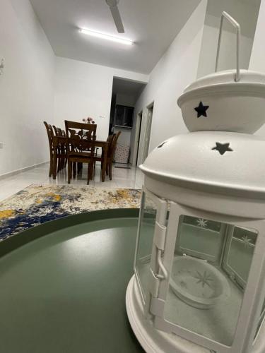 - une horloge assise sur une table dans le salon dans l'établissement Hanz Homestay Melaka - For Malay Only, à Malacca