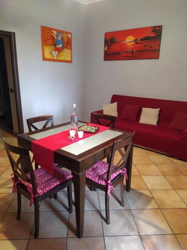 a living room with a table and chairs and a couch at Fercla appartamento in Fiano Romano