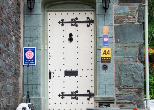 a white door with a dog standing in front of it at Hazel Bank Country House Borrowdale Valley in Rosthwaite