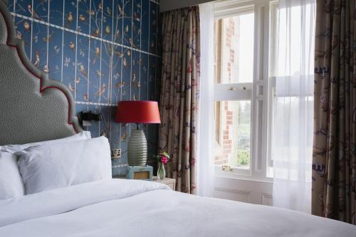 a bedroom with a bed and a window at Pendley Manor in Tring