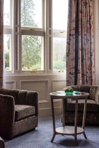 a living room with a couch and a table at Pendley Manor in Tring