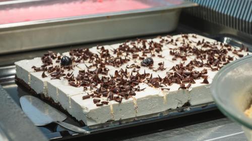 a cake with chocolate toppings on top of it at Silver Beach Hotel & Apartments in Gerani Chanion