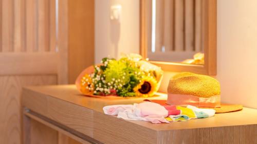a counter with a pile of clothes and a mirror at Silver Beach Hotel & Apartments in Gerani Chanion