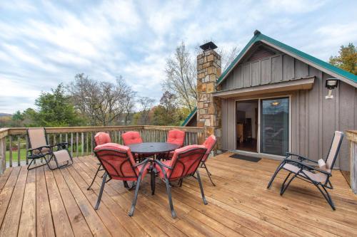 a patio with a table and chairs on a deck at Friendly Bear Two in Sevierville