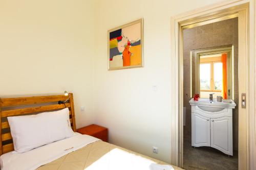 a bedroom with a bed and a sink at Villa Luni in  Episkopi (Chania)