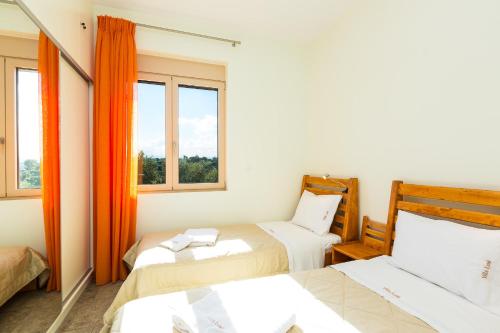 a room with two beds and two windows at Villa Luni in  Episkopi (Chania)