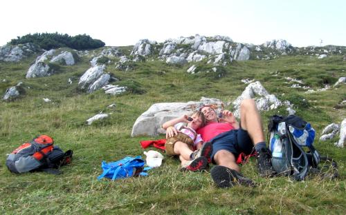 a group of people laying in the grass on a hill at Ferienhaus Melita in Bleiburg