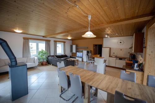 a kitchen and living room with a wooden ceiling at Chalet 48 in Hermagor