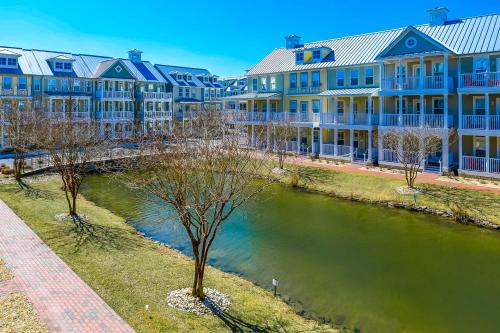 a row of blue apartment buildings next to a river at Sunset Island - 35 Seaside in Ocean City