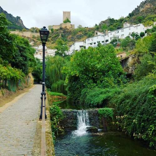 a street light next to a river with a waterfall at Alojamiento Entradita Cazorla in Cazorla