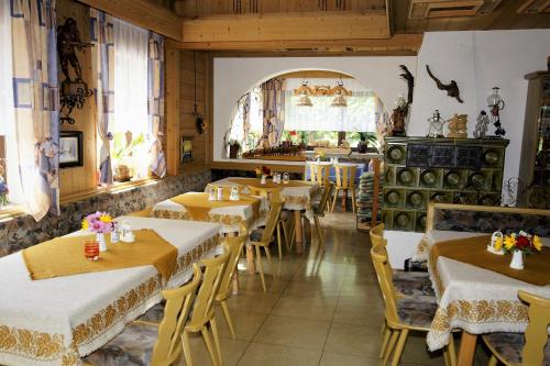 ein Restaurant mit Tischen und Stühlen in einem Zimmer in der Unterkunft Bellas Mühlbachtal in Friedenfels