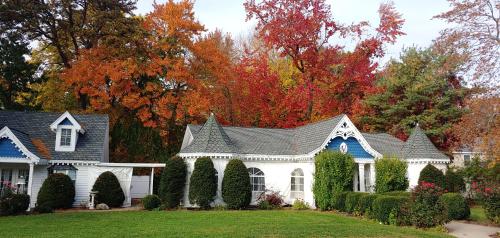 a white house with a blue roof at Victoria Inn in Hampton