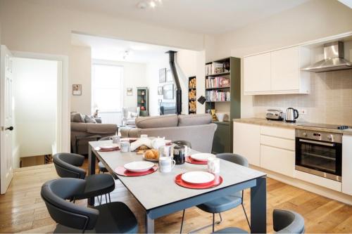a kitchen and living room with a table and chairs at Spencer House & 107 & 109 Nunnery Lane in York