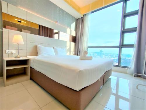 a bedroom with a large bed with a large window at Infini Suites@ The Robertson Bukit Bintang in Kuala Lumpur