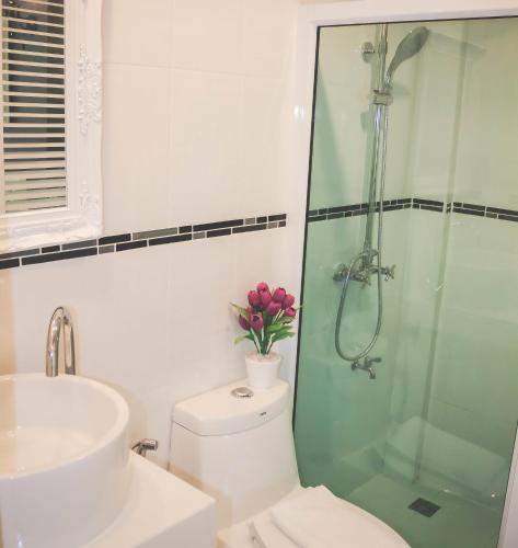 a bathroom with a shower and a toilet and a sink at Jasmine Chiangmai Boutique Hotel in Chiang Mai
