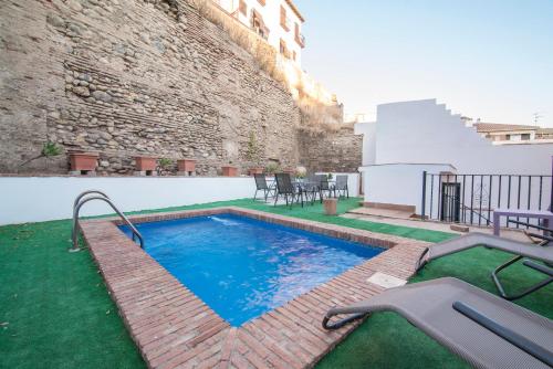 a swimming pool in front of a building at Apartamentos Granata in Granada