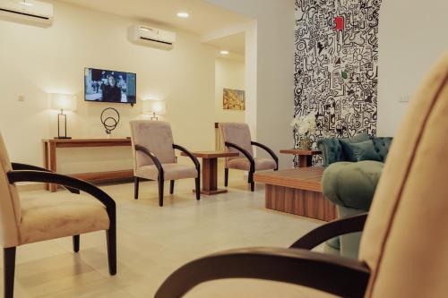 a waiting room with chairs and a couch and a table at Sinclair Lake Chad in Abuja