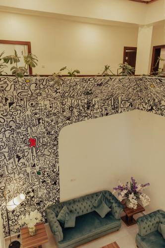 a living room with a wall covered in black and white wallpaper at Sinclair Lake Chad in Abuja