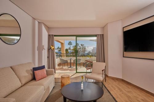 a living room filled with furniture and a tv at Dreams Lanzarote Playa Dorada Resort & Spa in Playa Blanca