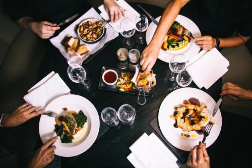 um grupo de pessoas sentadas à volta de uma mesa a comer em Crown Lodge Hotel em Wisbech