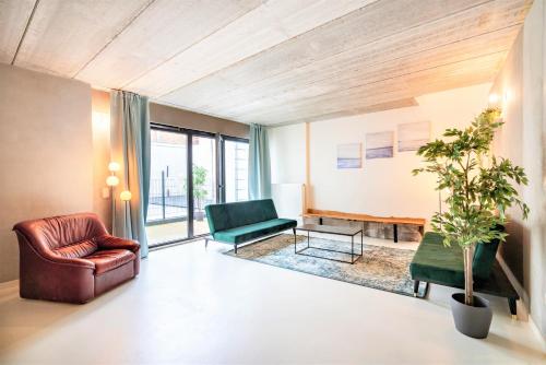 a living room with a couch and a chair at Antwerps Central Residence in Antwerp