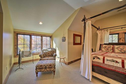 een slaapkamer met een bed en een stoel in een kamer bij Eagle View Lodge - Luxury Home with Hot Tub! in Waynesville