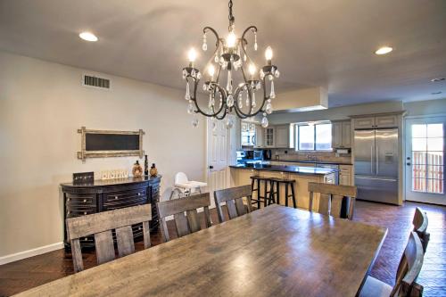 a dining room and kitchen with a table and a chandelier at House with Game Room Less Than 3 Mi to Wine Tastings! in Clarkdale