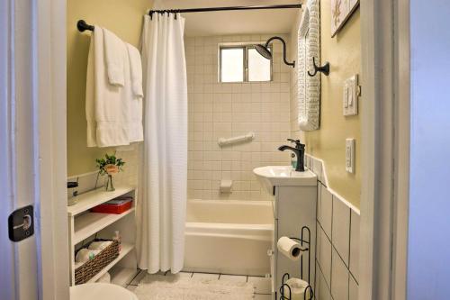 a bathroom with a tub and a toilet and a sink at Lake Arrowhead Studio with Private Hot Tub! in Lake Arrowhead