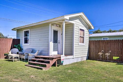 a small white house with a porch and a fence at Flirty Flamingo Studio 1 Mi to Canyon Lake in Canyon Lake