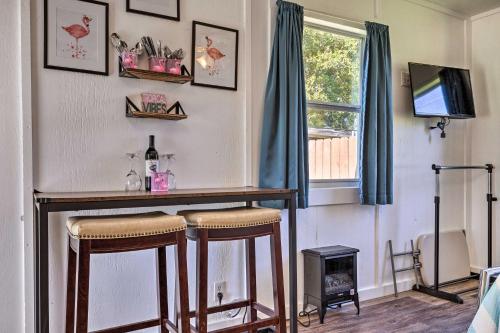a bar in a room with two stools and a television at Flirty Flamingo Studio 1 Mi to Canyon Lake in Canyon Lake