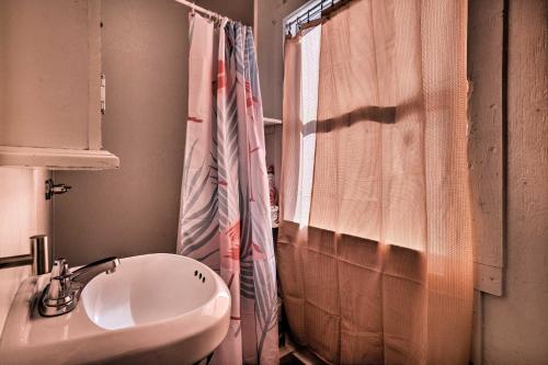 a bathroom with a sink and a shower curtain at Flirty Flamingo Studio 1 Mi to Canyon Lake in Canyon Lake