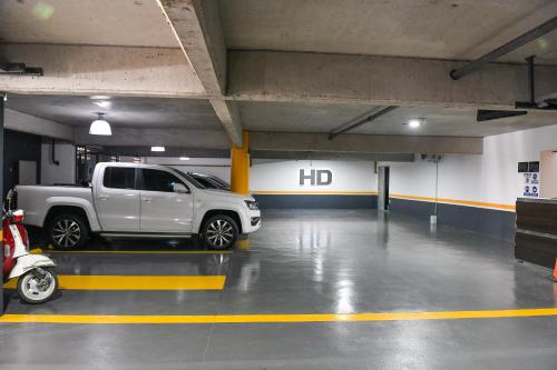 a parking garage with a truck parked in it at Hotel Denver Mar del Plata in Mar del Plata