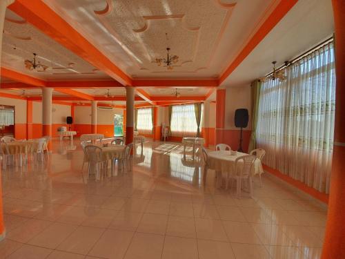 a banquet hall with tables and chairs in a room at Hotel El Cristo in Cobija