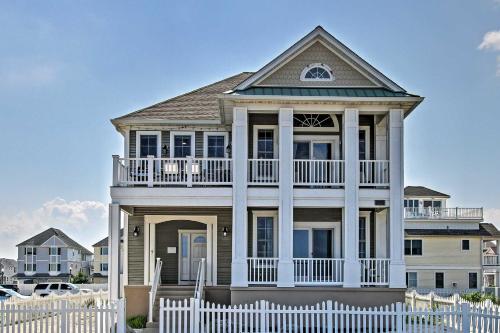 a house with a white fence in front of it at Idyllic Oceanfront Home on Atlantic City Boardwalk in Atlantic City