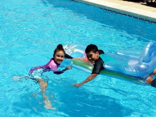 a man and a little girl in a swimming pool at Casa Algorfa Alicante Spain in Algorfa