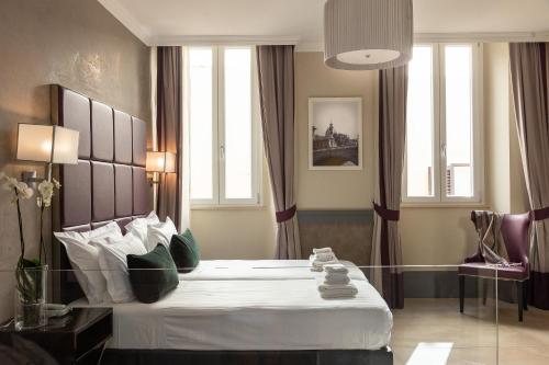 Un ou plusieurs lits dans un hébergement de l'établissement Hotel Castellino Roma