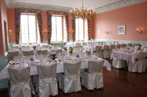 a banquet hall with white tables and chairs at Hotel Rheinfels in Stein am Rhein