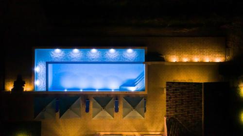 a large blue screen with lights on top of a building at Aneli Luxury Villas - Villa Semeli in Zakynthos Town