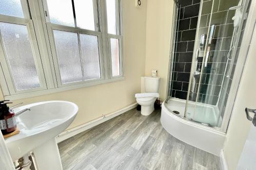 a bathroom with a sink and a toilet and a shower at Elegant Studio 5 mins Walk to Coventry Transport Museum in Coventry