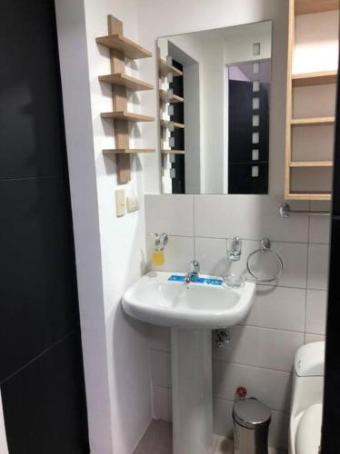 a bathroom with a sink and a mirror and a toilet at 2 room department (5 people). Private exclusive area in Guayaquil in Guayaquil